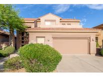 Charming two-story home featuring a tile roof and well-maintained landscaping at 22063 N 77Th St, Scottsdale, AZ 85255