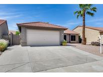 Charming single-story home featuring a two-car garage, concrete driveway, and a well-maintained desert landscape with a palm tree at 2730 E Desert Trumpet Rd, Phoenix, AZ 85048