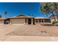 Charming single-story home with a two car garage, desert landscaping and a covered entrance at 3030 S Rogers --, Mesa, AZ 85202