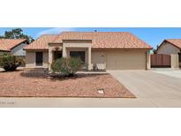 Charming single-story home featuring a terracotta tile roof, desert landscaping, and a two-car garage at 5860 W Saragosa St, Chandler, AZ 85226