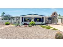 Charming single-story home featuring a rock yard, covered parking, and mature trees at 632 S 83Rd Way, Mesa, AZ 85208