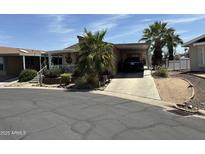 Charming single-story home with covered parking and well-maintained landscaping under a blue sky at 11411 N 91St Ave # 229, Peoria, AZ 85345