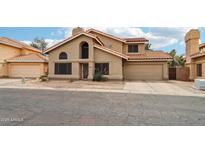 Two-story home featuring a tile roof, neutral stucco, and a two-car garage at 1344 N Brittany Ln, Gilbert, AZ 85233