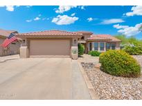 Inviting single-story home showcasing a neutral color palette, low maintenance desert landscaping, and a spacious two-car garage at 15502 W Agua Linda Ln, Surprise, AZ 85374