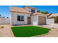 Charming two-story home featuring fresh exterior paint, low maintenance desert landscaping, and attached garage at 1605 W Curry Dr, Chandler, AZ 85224