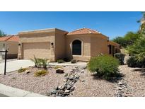 Charming single-story home boasting a well-manicured desert landscape, a two car garage and a tile roof at 17349 E Quail Ridge Dr, Fountain Hills, AZ 85268