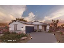 Charming single-story home featuring a stone-accented facade and a well-manicured front yard with desert landscaping at 17565 N Bolerno Dr, Maricopa, AZ 85138