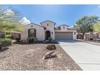 Charming single-story home featuring desert landscaping, a two-car garage, and covered entry at 18149 W Turney Ave, Goodyear, AZ 85395