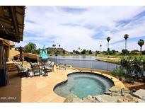 Enjoy this backyard with a private spa overlooking a lake and golf course at 21609 N 61St Ave, Glendale, AZ 85308