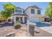 Charming two-story home with a well-manicured front yard and inviting curb appeal, painted in an attractive neutral color at 2847 S 161St Dr, Goodyear, AZ 85338