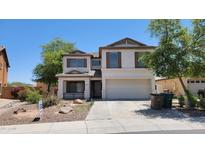 Two-story home featuring a two-car garage and desert landscaping at 2847 S 161St Dr, Goodyear, AZ 85338