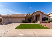 Beautiful single-story home showcasing desert landscaping, manicured lawn, and a spacious three-car garage at 3740 W Kent Dr, Chandler, AZ 85226