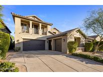 Stunning two-story home featuring a three-car garage and manicured landscaping at 3741 E Ember Glow Way, Phoenix, AZ 85050