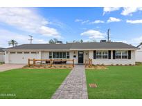 Charming single-story home with white brick and a welcoming front patio at 4018 E Coolidge St, Phoenix, AZ 85018