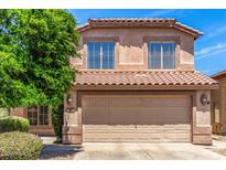Exterior elevation of home featuring a tile roof and an attached two-car garage at 4426 E Coyote Wash Dr, Cave Creek, AZ 85331