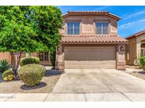 Exterior elevation featuring a two-story home with a tile roof and a well-maintained front yard with desert landscaping at 4426 E Coyote Wash Dr, Cave Creek, AZ 85331