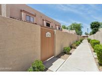 Exterior view of unit with private entrance, pathway, and tan stucco walls at 4734 W Golden Ln, Glendale, AZ 85302