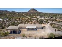 Aerial view of property featuring a car port, desert landscape and mountain views at 48451 N 27Th Ave, New River, AZ 85087