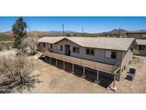 A beautiful single-story home featuring a large deck and mountain views at 48451 N 27Th Ave, New River, AZ 85087