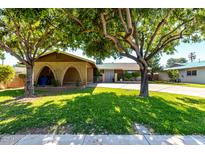 Charming single-story home with mature trees and a well-maintained lawn at 518 N Cheri Lynn Dr, Chandler, AZ 85225