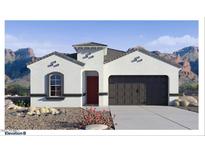 Charming single-story home featuring stucco siding, a dark garage door, and desert landscaping with mountain views at 7303 W Buckhorn Trl, Peoria, AZ 85383