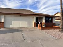 Charming single-story home featuring a two-car garage, brick accents, and a well-maintained front yard at 8161 E Keats Ave # 376, Mesa, AZ 85209