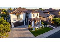 Impressive home with a well-manicured lawn, charming stone accents, and a spacious driveway, creating a welcoming curb appeal at 861 E Canyon Way, Chandler, AZ 85249