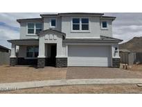 Charming two-story home features a covered entryway, a two-car garage, and neutral-toned stucco at 10043 S 23Rd Dr, Phoenix, AZ 85041