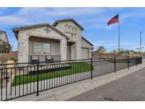 Charming single-Gathering home featuring a gray brick exterior, fenced yard, and an American flag at 1145 E Gleneagle Dr, Chandler, AZ 85249