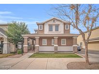 Charming two-story home with a covered porch and well-manicured lawn for curb appeal at 12022 W Belmont W Dr, Avondale, AZ 85323