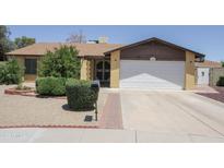 Charming one-story home featuring desert landscaping, an attached two-car garage, and a covered entryway at 13012 N 26Th Dr, Phoenix, AZ 85029