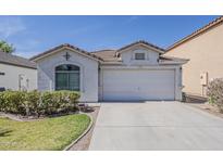 Charming single-story home featuring a tile roof, two-car garage, and well-maintained landscaping at 1396 E Leslie Ave, San Tan Valley, AZ 85140