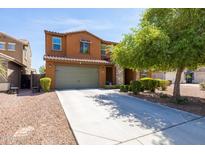 Charming two-story home with a well-manicured front yard and a two-car garage at 18649 W Williams St, Goodyear, AZ 85338