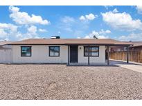 Charming single-story home featuring a covered porch, neutral paint, and low maintenance front yard at 2022 N 61St Ave, Phoenix, AZ 85035