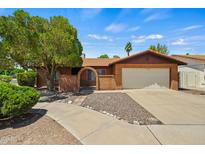 Charming single-story brick home featuring a tile roof and well-manicured front yard at 2264 S Don Carlos --, Mesa, AZ 85202