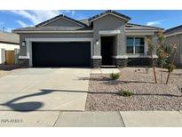 Charming single story home with a well-maintained gravel yard and a two car garage at 38055 W Excussare Way, Maricopa, AZ 85138
