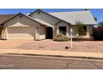 Charming single-story home with a two-car garage and low maintenance landscaping at 3932 E Tierra Buena E Ln, Phoenix, AZ 85032