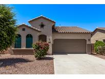 Charming single-story home with a well-manicured yard and a two-car garage, creating inviting curb appeal at 41103 W Rio Bravo Dr, Maricopa, AZ 85138