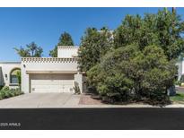 Inviting two-story home featuring a two-car garage and desert landscaping at 4226 N 69Th Pl, Scottsdale, AZ 85251