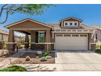 Charming single-Gathering home with a two-car garage, desert landscaping, and a covered front porch at 4898 N 206Th Ln, Buckeye, AZ 85396