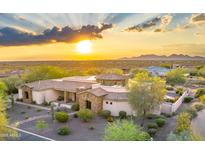 Stunning desert home showcasing a grand entrance, beautiful stone accents, and professionally landscaped yard at 6551 E Flat Iron Loop, Gold Canyon, AZ 85118