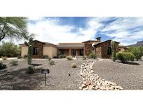 Inviting desert home featuring stonework accents and drought-tolerant landscaping at 6551 E Flat Iron Loop, Gold Canyon, AZ 85118