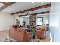 Cozy living room features wood beams, stone fireplace, and comfortable seating arrangement at 8214 N 16Th St, Phoenix, AZ 85020