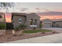 Charming single-story home showcasing a well-manicured lawn and paver driveway at 11957 W Daley Ln, Sun City, AZ 85373