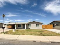 Charming single-story home with tidy landscaping, carport, and desert charm at 12230 N 47Th Dr, Glendale, AZ 85304