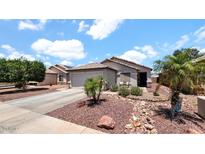 Charming home featuring low maintenance desert landscaping and a tile roof at 14952 W Maui Ln, Surprise, AZ 85379