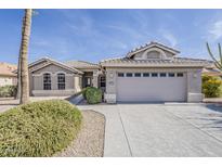 Charming single-story home with a well-manicured yard and a spacious two-car garage at 15411 W Amelia Dr, Goodyear, AZ 85395
