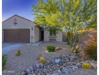 Charming single-story home with desert landscaping, a bench, and a cozy front entrance at 1654 E Jardin Pl, Casa Grande, AZ 85122