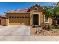 Inviting single-story home featuring a two-car garage and desert landscaping in front at 16954 W Mohave St, Goodyear, AZ 85338