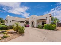 A charming single-story home with desert landscaping, a tile roof, and a wide concrete driveway at 19347 E Thornton Rd, Queen Creek, AZ 85142